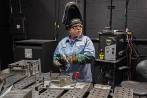 Laser Craft Tech employee working on a welding project in a fabrication bay