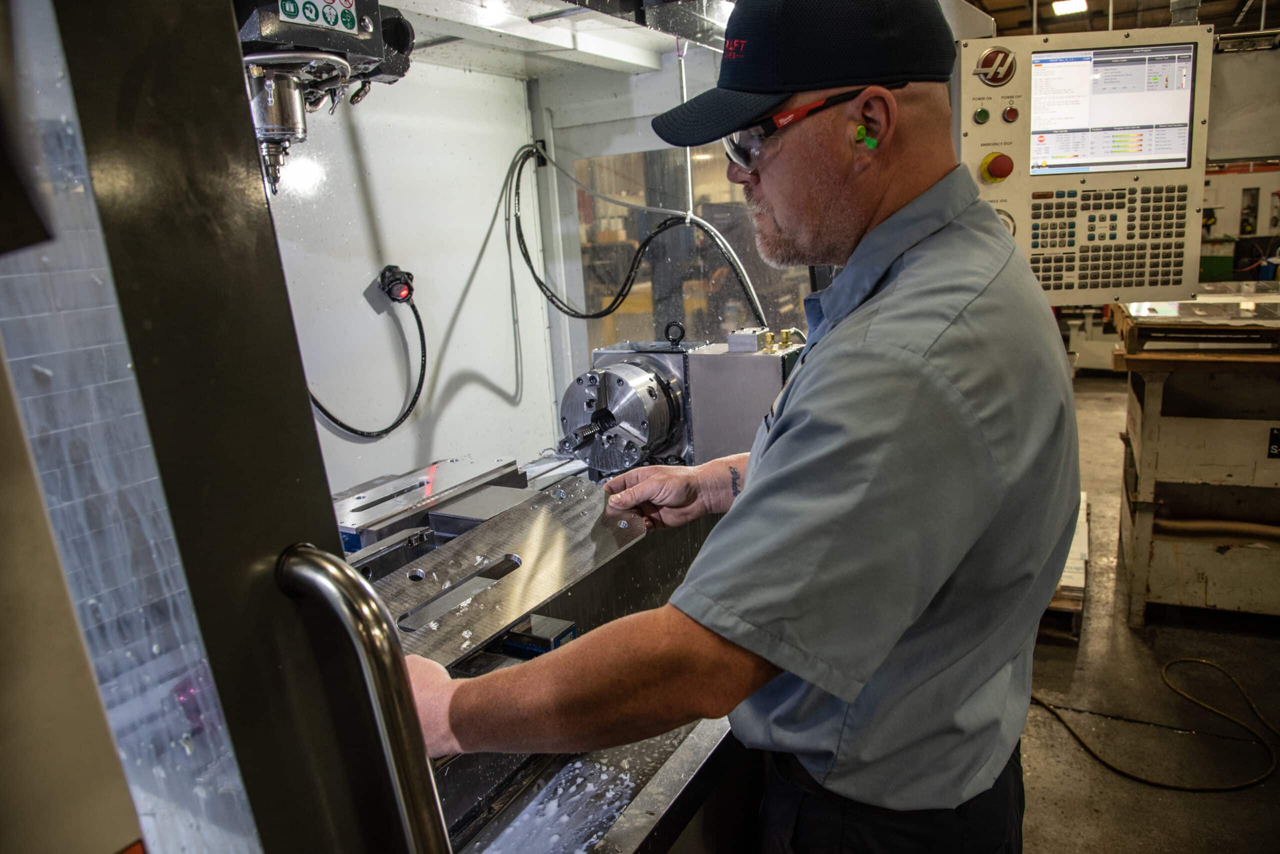 LaserCraft employee using precise cutting machinery