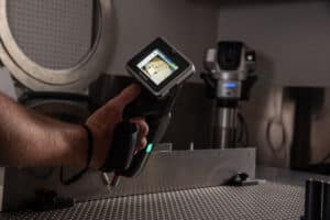 Laser Craft Tech employee operates a digital measuring device