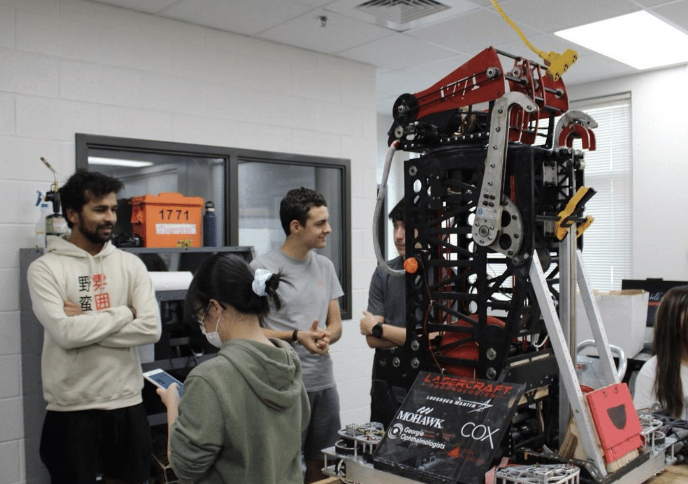 Laser Craft Tech employees having a discussion inside a break room