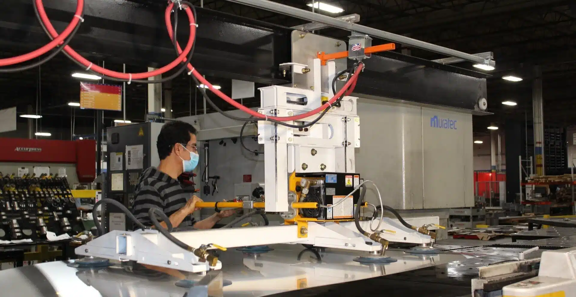 Laser Craft Tech Tech Employee uses a machine in a shop